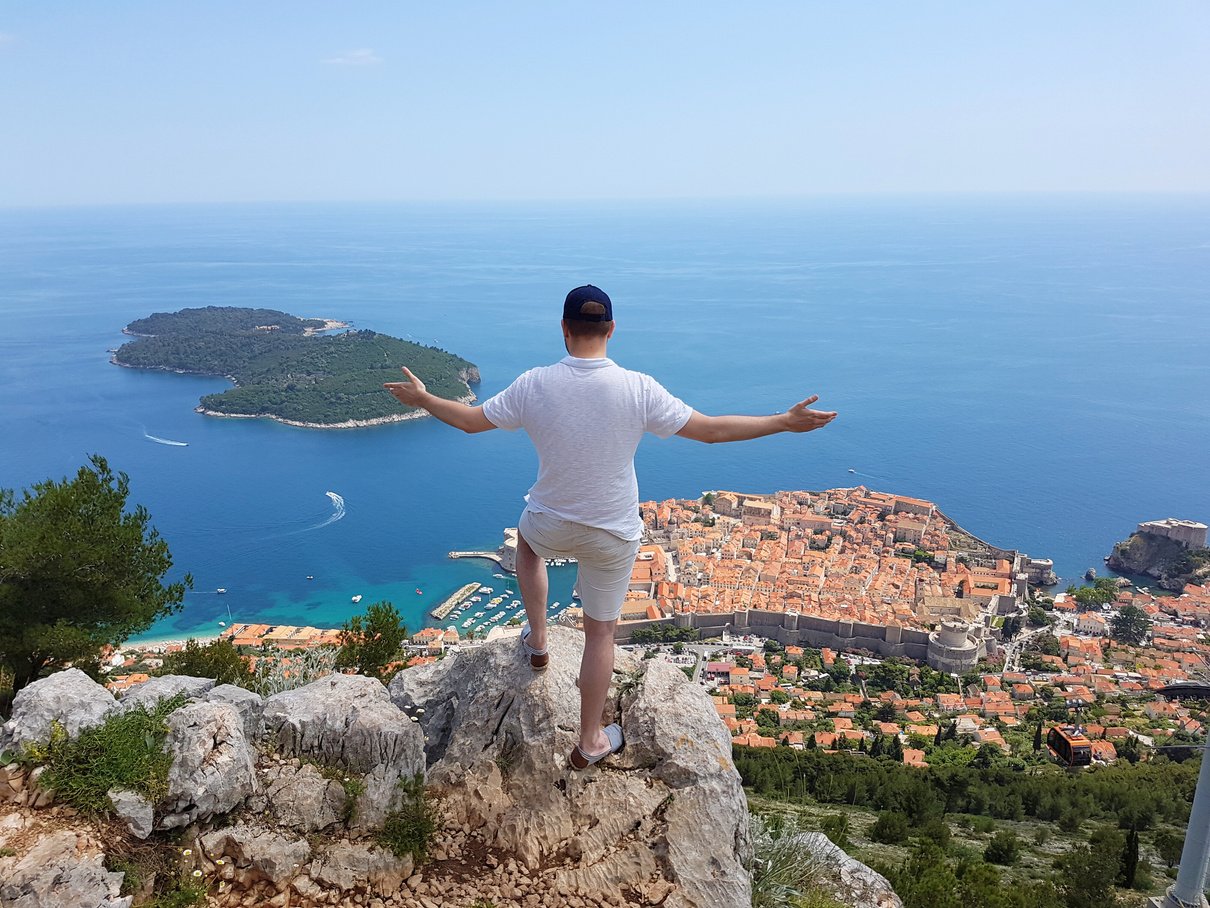 Chris Jones standing on top of a mountain overlooking the city of Dubrovnik, Croatia.